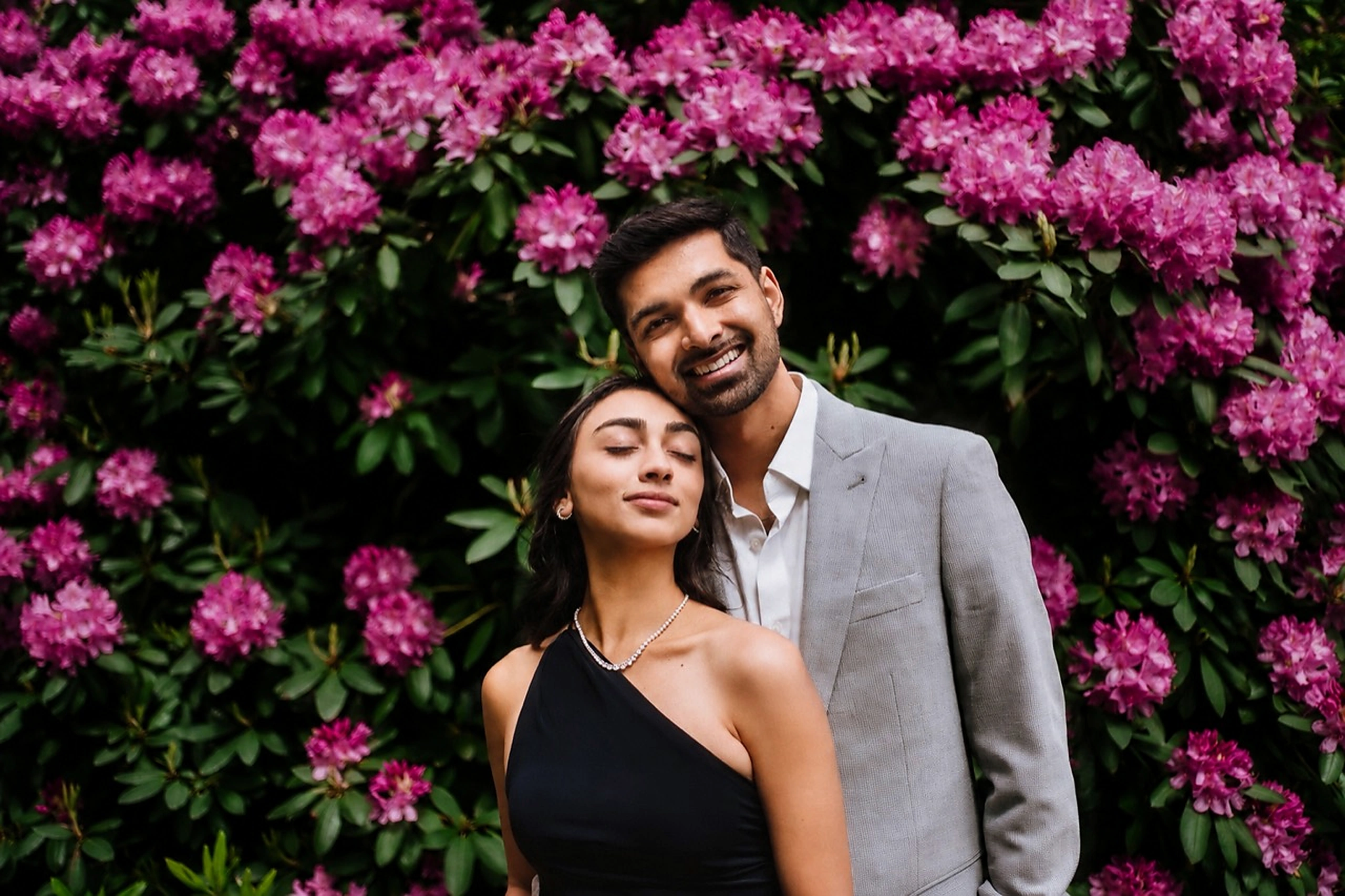 Devesh and Charmi together in front of flowering rhododendrons