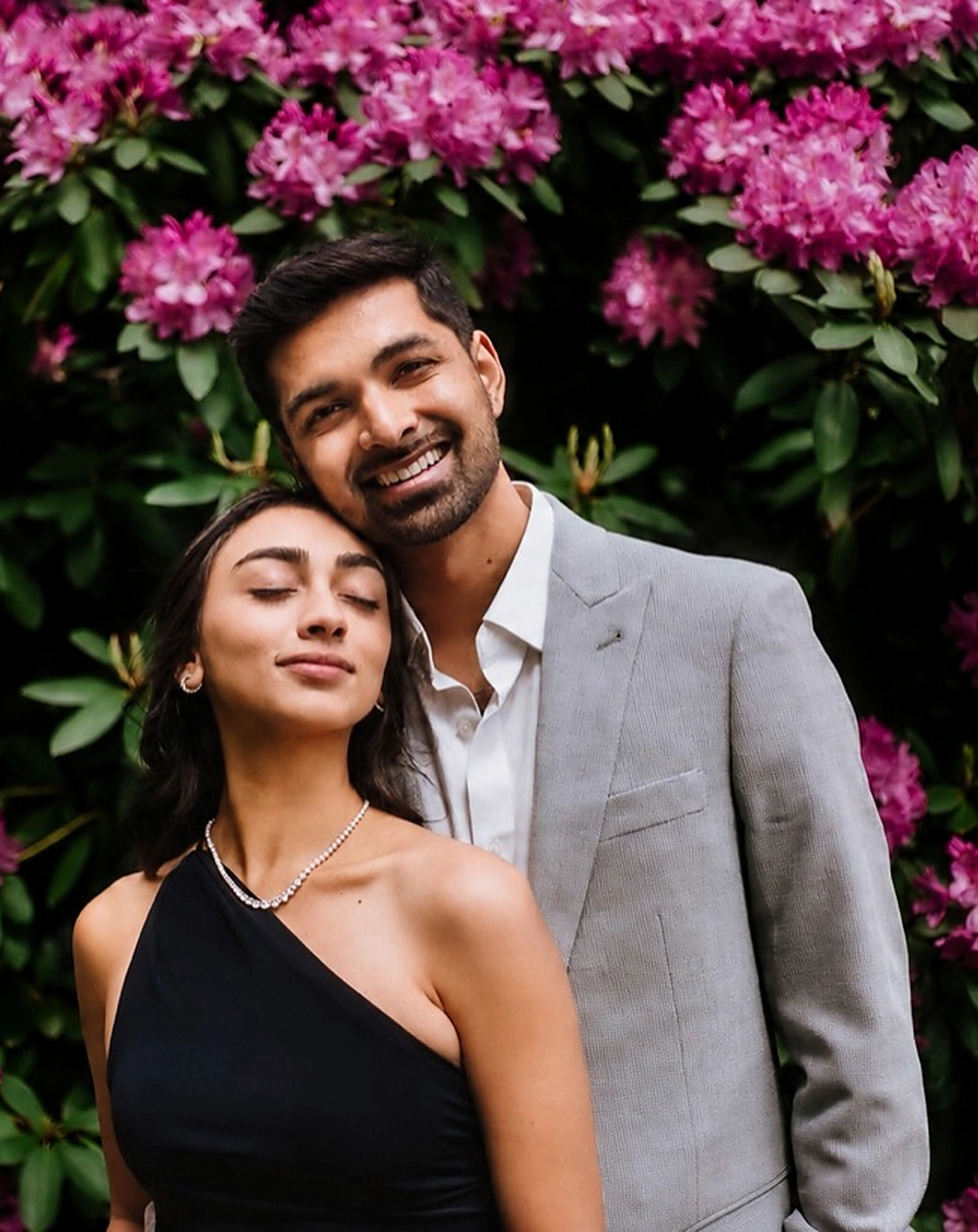 Devesh and Charmi together in front of flowering rhododendrons